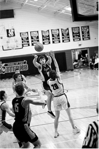 Colton Bailly passes to Garret Willits. Photo by Ashley Schafer