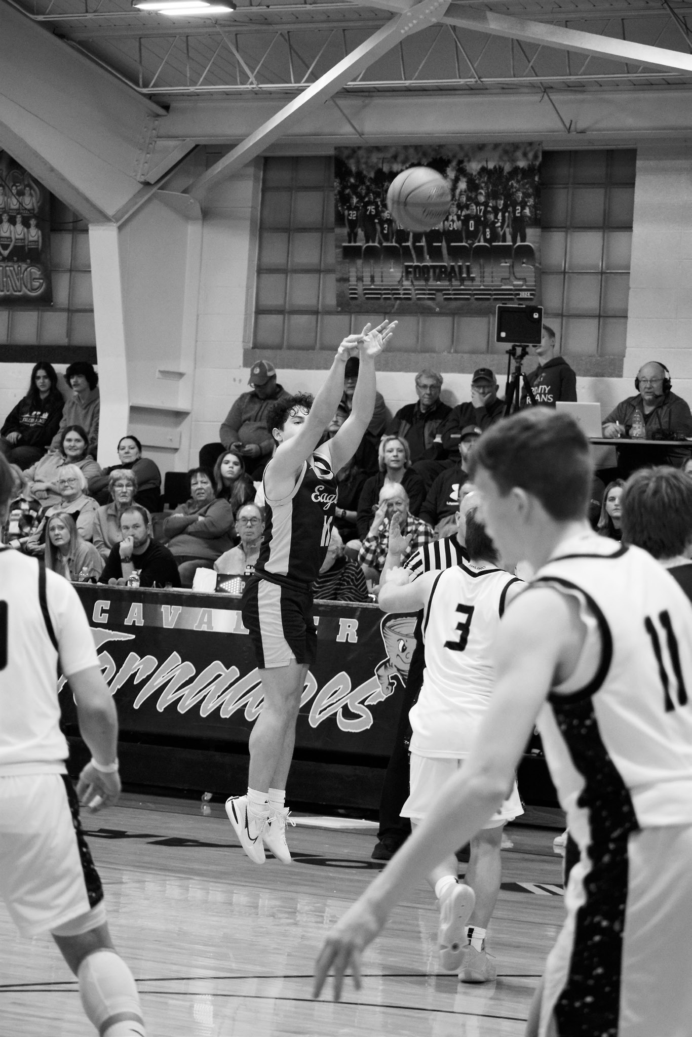 Grant Cosley shoots a 3-pointer against the Tornadoes on Jan. 9. Photo by Ashley Schafer.