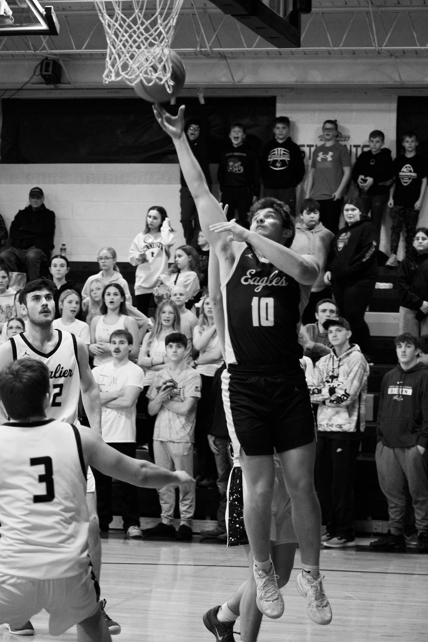 Colton Bailly goes in for a layup in the Eagles’ game against Cavalier. Photo by Ashley Schafer.