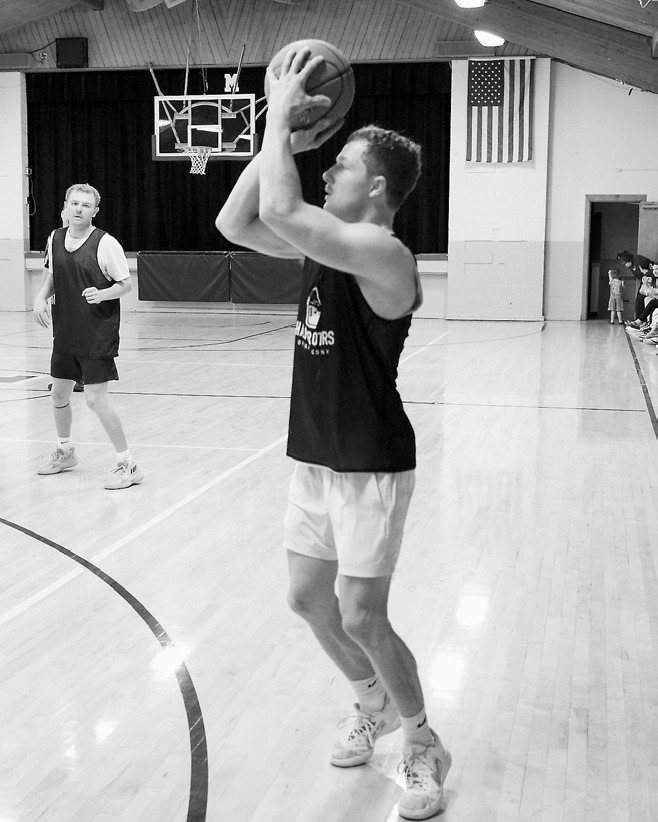Jacob Delvo drains a 3-point basket at the Amateur Tourney. Photo by Larry Stokke.