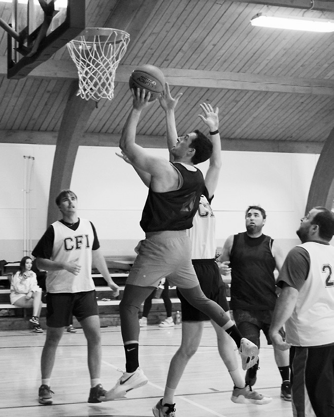 Zack Schaefer drops in a left-handed layup in Munich on April 12 in the Amateur Tourney. Photo by Larry Stokke.