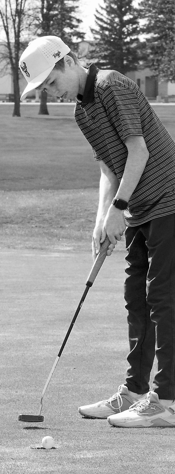 Dyson Askvig sinks a putt at Grafton on May 14. Photo by Larry Stokke.