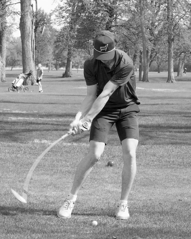 Zeek Symington puts a bend in his club while teeing off in Grafton on May 14. Photo by Larry Stokke.