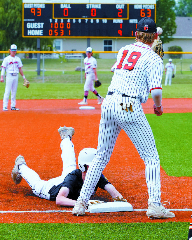 Sam Davis beats the ball to 3rd base against Larimore. Photo by Larry Stokke.