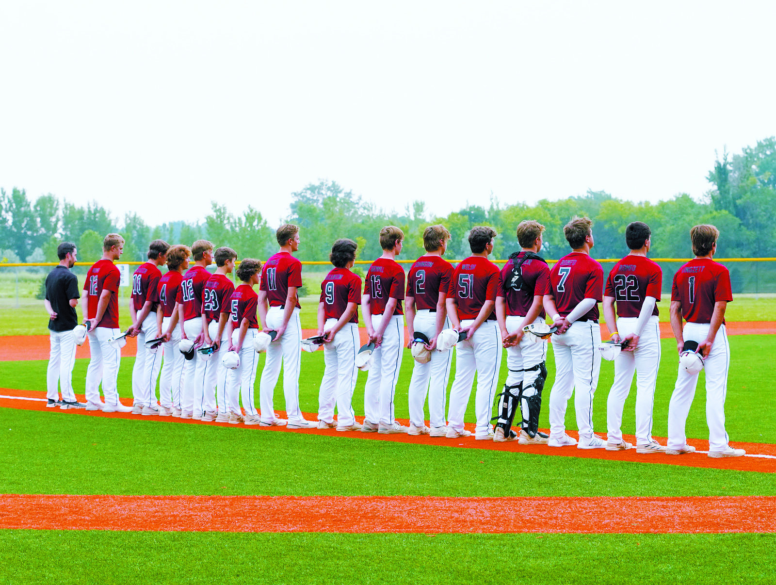 Langdon’s Post 98 Legion team stands for the National Anthem in Park River at the Regional Tournament. Photo by Larry Stokke.