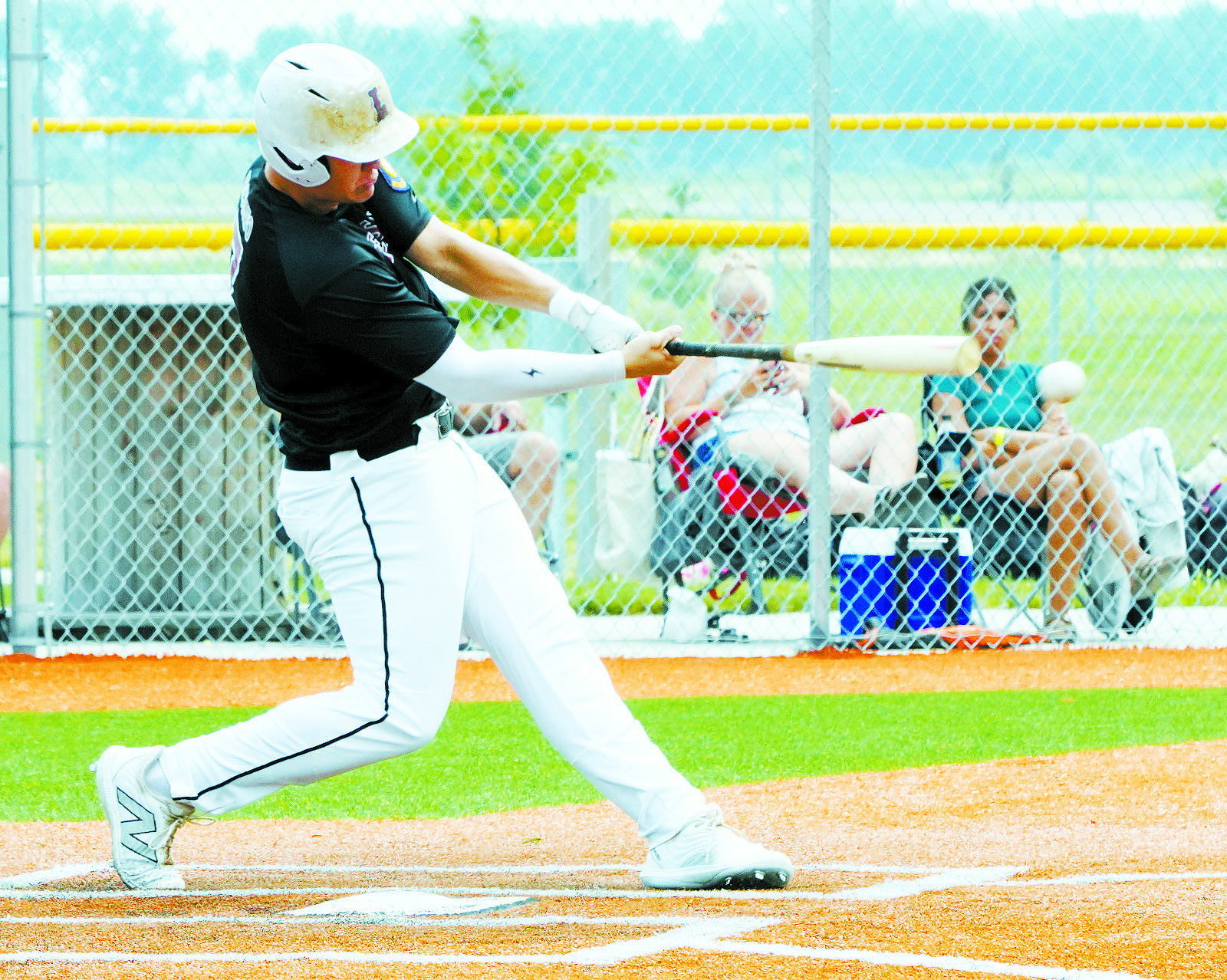 Theo Romfo connects for a base hit. Photo by Larry Stokke.