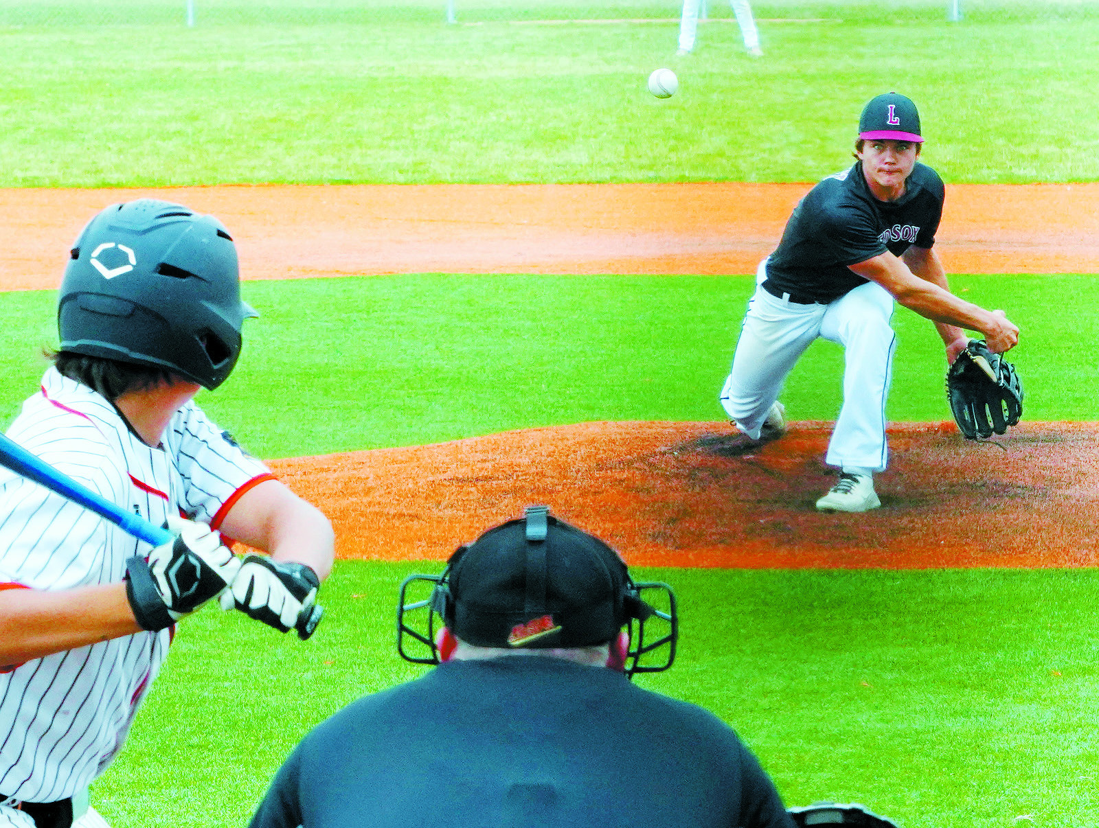 Nick Kingzett eyes the Larimore batter and sends a strike across the plate. Photo by Larry Stokke.