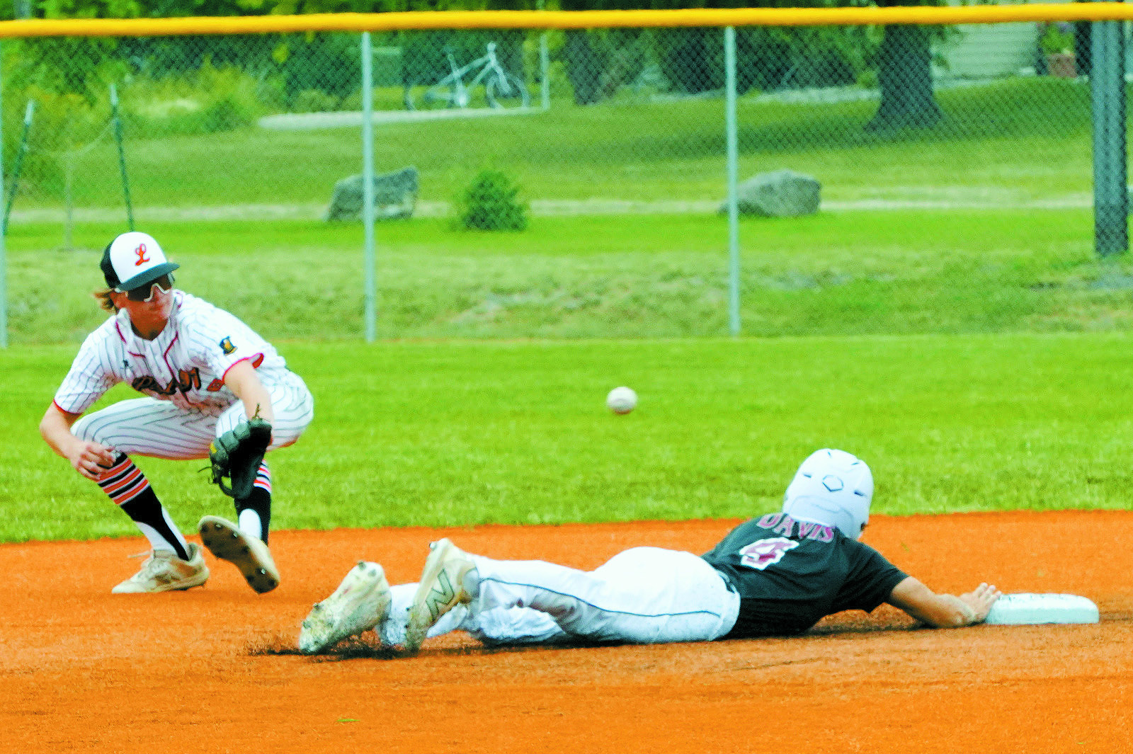 Sam Davis dives back to 2nd base under the ball. Photo by Larry Stokke.