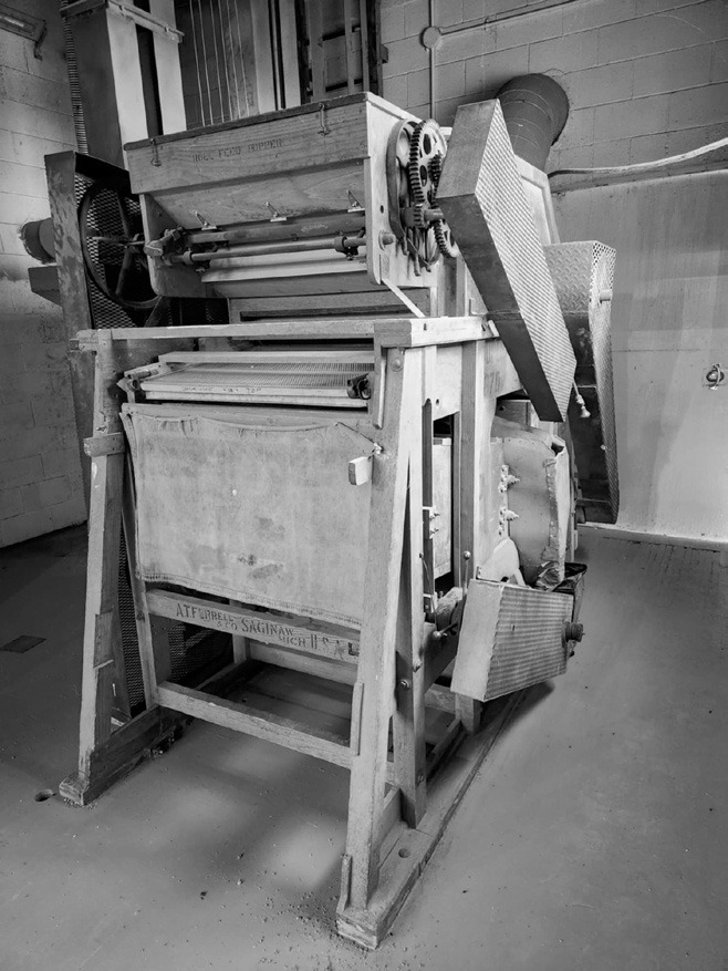 An antique piece of equipment still being used inside of the seed cleaning facility. Photo by Hilary Nowatzki.