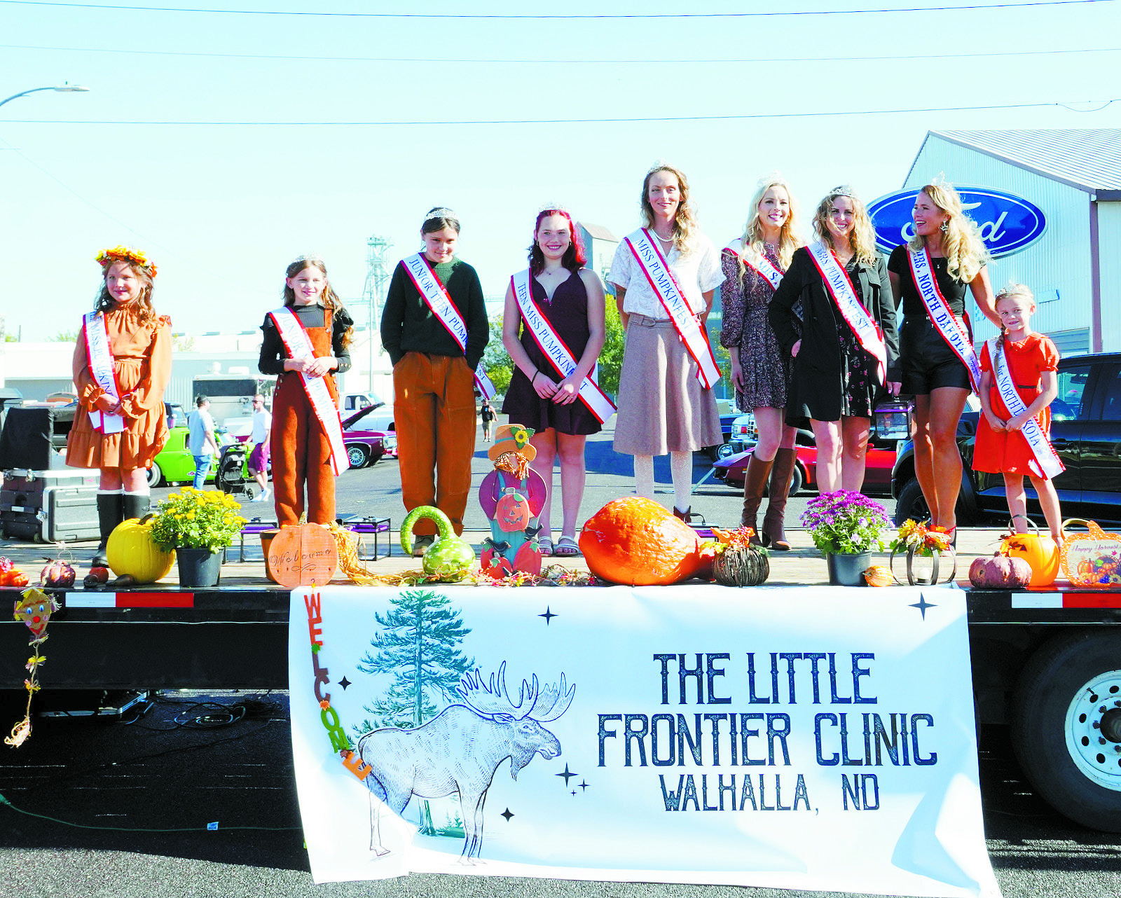 Pumpkinfest Pageant winners (L-R) Corbynn Corbit, Zoey Sveen, Amelia Ripple, Zoey Skjerva, Hilary Nowatzki, Queen Casssandra Van Dell (Mrs. North Dakota America), Tara Emerson, Queen Jennifer Steiner (Mrs. North Dakota America), and Queen Dixie Gowan (Little Miss North Dakota America). Photo by Larry Stokke.