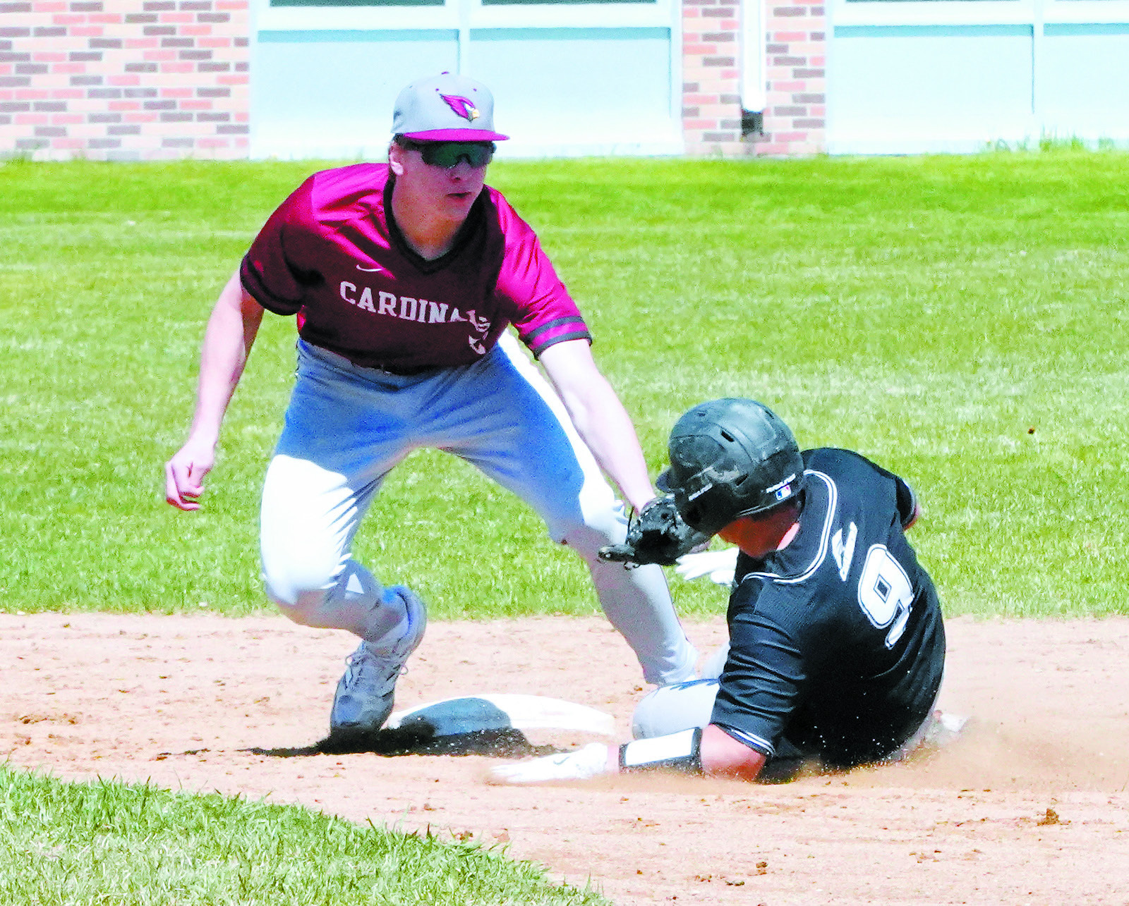 Jax Johnson tags out a Nelson County player at second base. Photo by Larry Stokke.