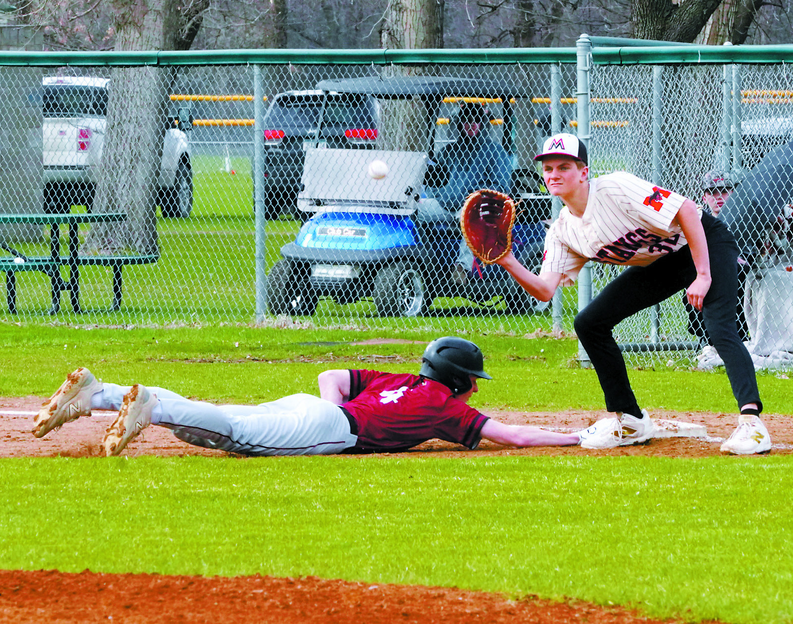 Tyson Gemmill beats the ball back to first base in the Cards’ win over Midway/Minto. Photo by Larry Stokke.