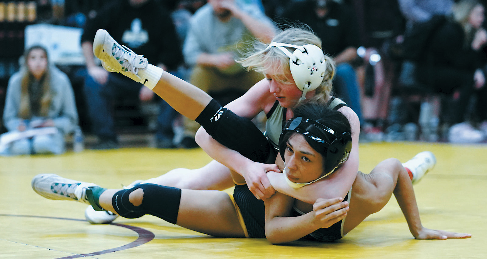 Charlotte Crowston wraps up her opponent in Belcourt, pinning her for a win. Photo by Larry Stokke.