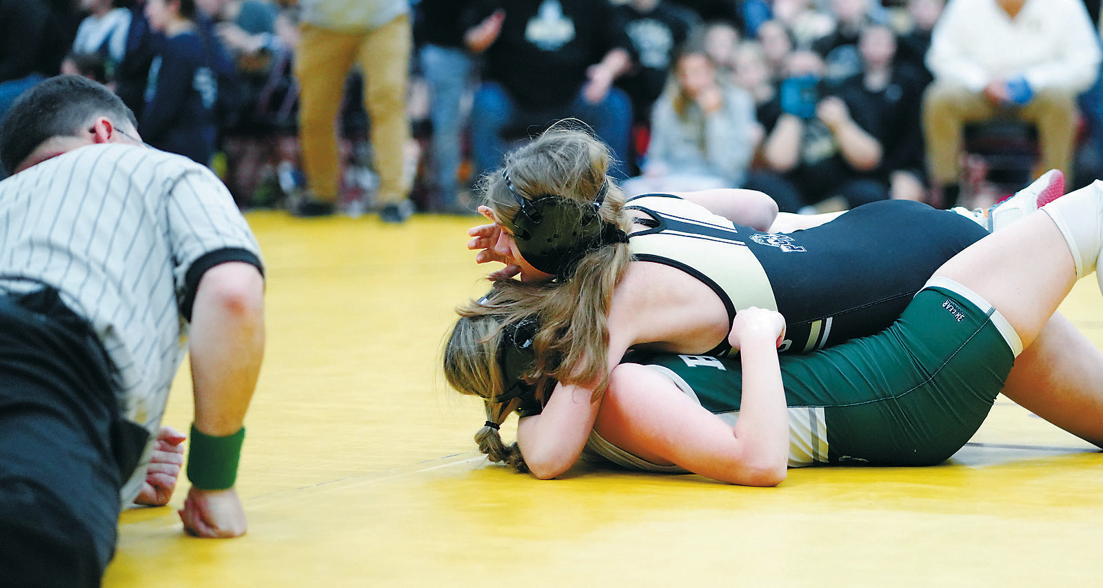Jalyn Carrigan pins her opponent in Belcourt on Dec. 6. Photo by Larry Stokke.