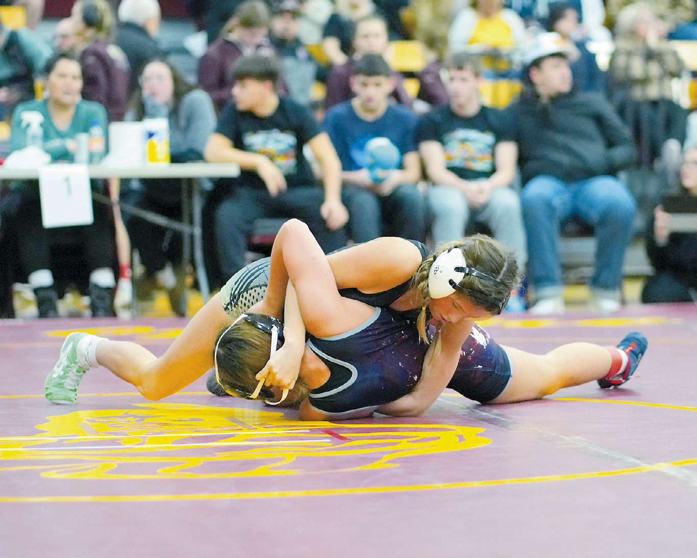 Zailynn Coffman in the 106 pound weight class won her match by pinning her opponent. Photo by Larry Stokke.