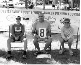 From left, Brennan Gellner, Kraig Gellner and Kiera Gellner pose after competing in the July 11 tournament. Submitted photo