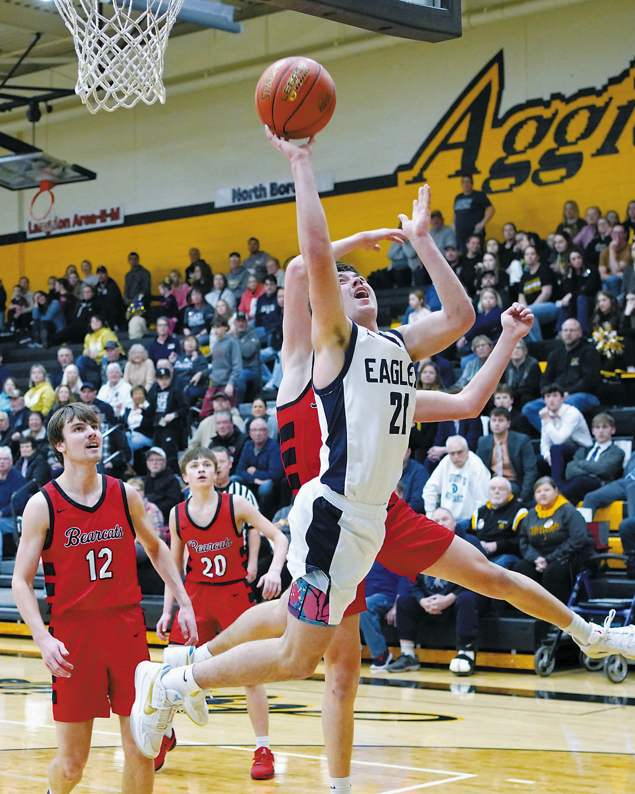 Brody Berg stretches out and drops in a basket. Photo by Larry Stokke. Kade Schafer nails a 3-point shot for the game-winning basket over the North Star Bearcats. Photo by Larry Stokke.