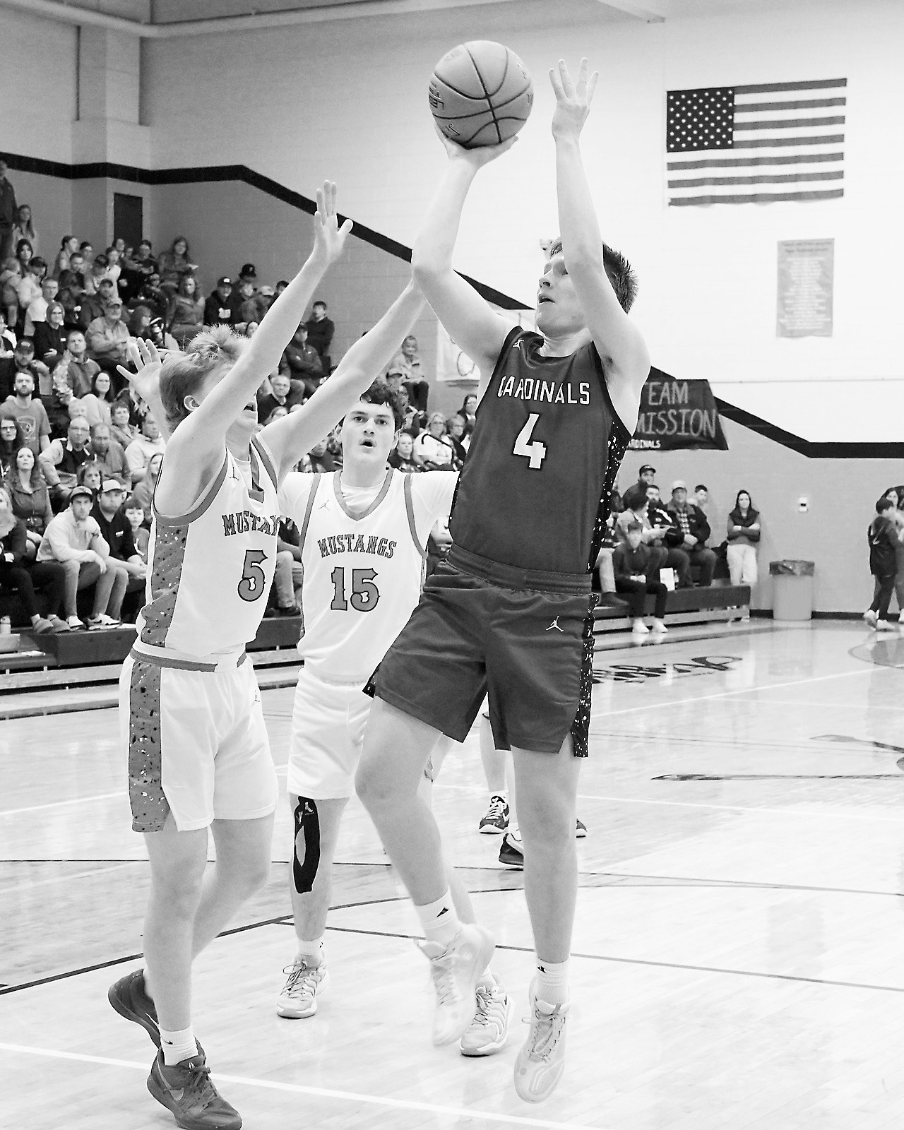Levi Swanson drops in a basket against the Mustangs. Photo by Larry Stokke.