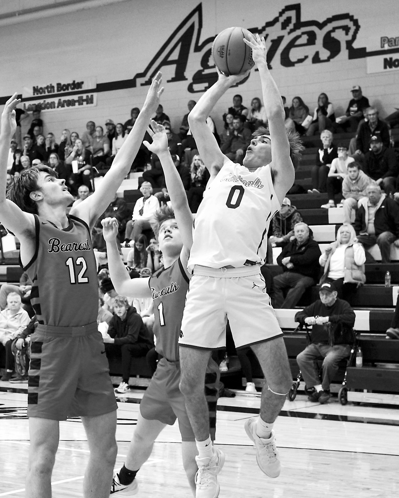 Jayden Lee shoots the ball over top Hunter Hagler. Photo by Larry Stokke.