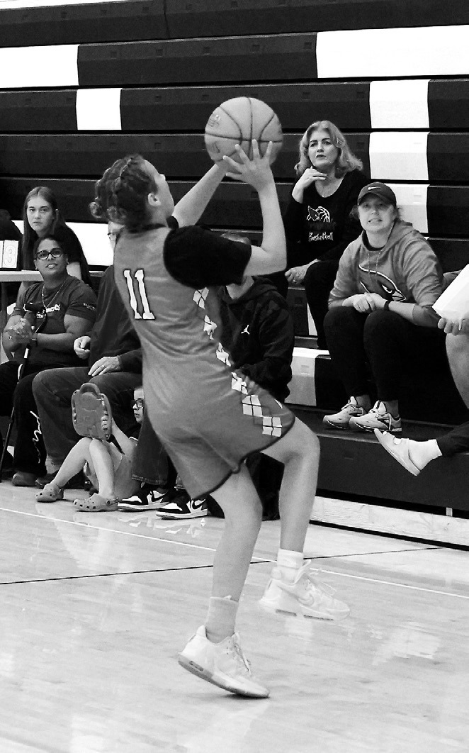 Brooklyn Mondor drives into the lane on a fastbreak and drops in a layup. Photo by Larry Stokke.