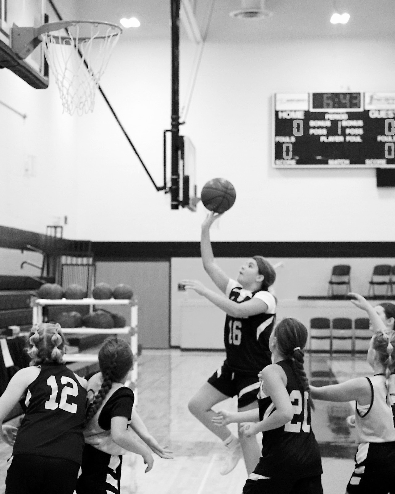 North Border Eagle Lauren Smith drives to the basket and lays in two points in the Park River Tournament. Photo by Larry Stokke.