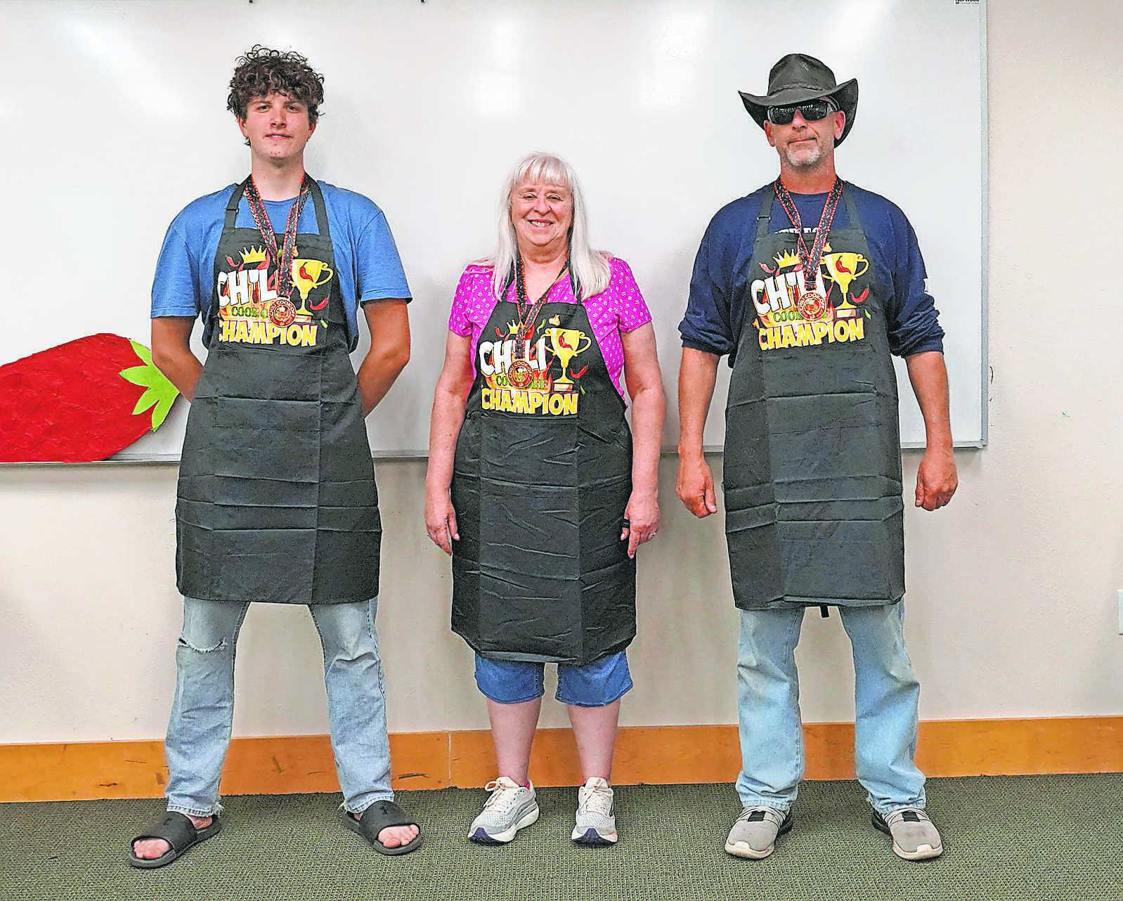 From (L-R) winners: Jonathan Lill for “tastiest,” Debbi Flowers for “spiciest,” and Robert Mackall for “fan favorite.” PHOTO BY LARRY STOKKE