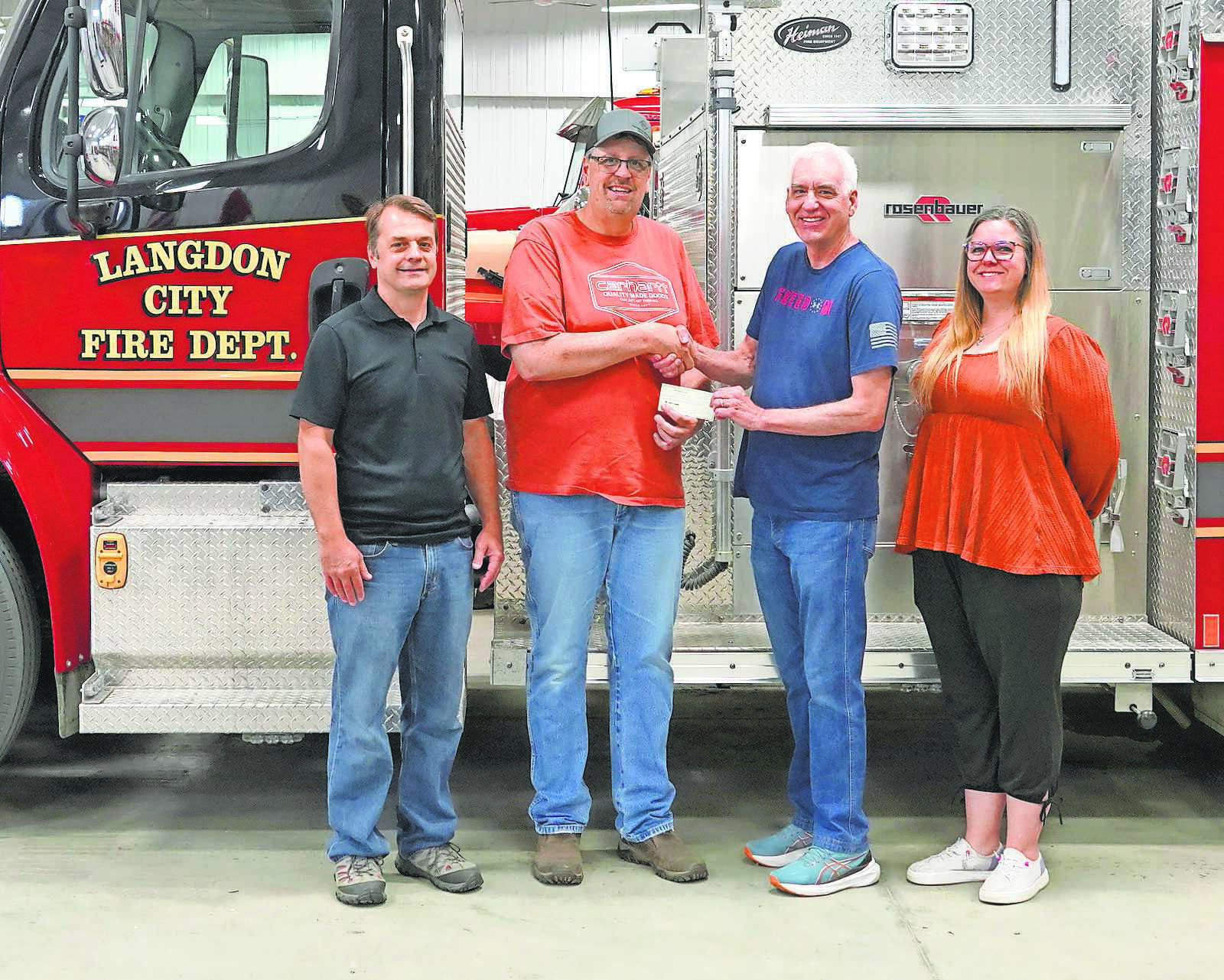 From (L-R) Jed Luhman (deacon at First Baptist), Mike Schrader (Langdon Fire Department), John Flowers (pastor at First Baptist), and Annamarie Lill. First Baptist Church awards one of three checks to Mike Schrader with the Langdon Fire Department. PHOTO BY LARRY STOKKE.