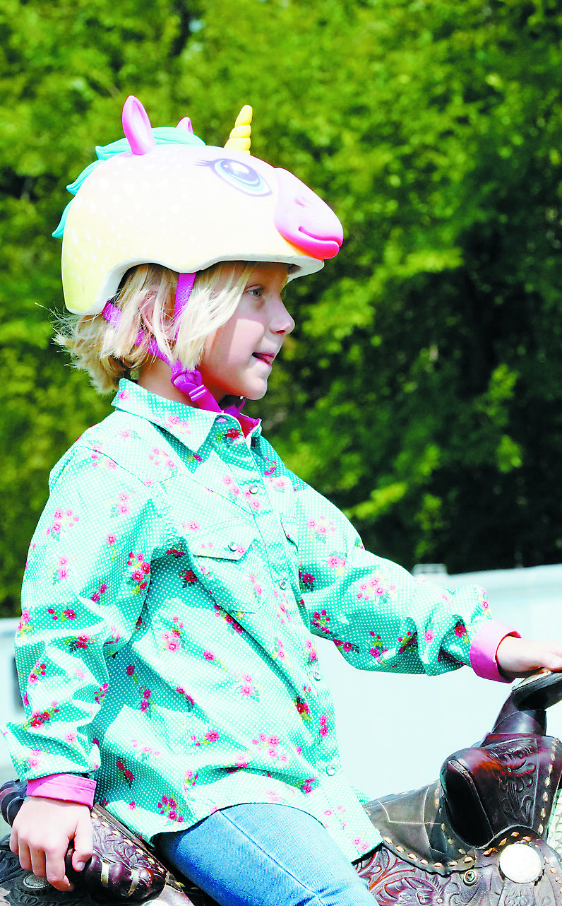 Lucy Bina in her cute unicorn helmet waits to compete. Photo by Larry Stokke.