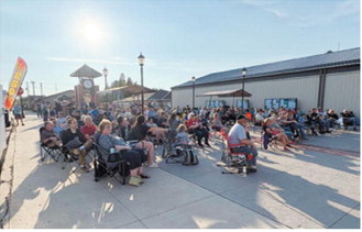 Community members gather at Boyd Block in downtown Langdon during the Northern Lights Arts Council Summer Concert Series. The free concerts drew large crowds throughout the three-week series, which featured local student, community and regional performers. Submitted photo