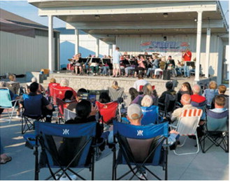 Audience members fill Boyd Block in downtown Langdon as the Langdon Community Band performs during the Northern Lights Arts Council Summer Concert Series on June 4. The free outdoor concert featured a variety of musical selections and drew residents together for an evening of live entertainment, food and community fellowship. Submitted photo