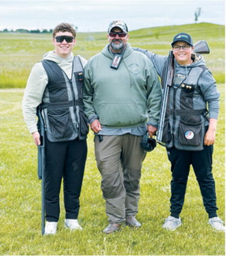 From left, Maddux Busse, Coach Josh Short and Gavin Rime share a moment during the 2026 ND State High School Skeet Tournament on June 13 in Bismarck. Submitted photo