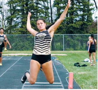 Jaylynn Stegman competes in the triple jump at the regional track meet, recording a jump of 29 feet, 11 inches. Photo by Larry Stokke