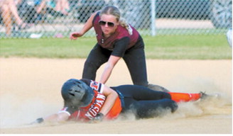 Harper Jacobson attempts a tag on a diving runner during Langdon's game at the league tournament July 14 in Minto. Photo by Larry Stokke