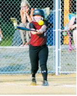 Kadence Wirth connects for a base hit during Langdon's game at the league tournament July 14 in Minto. Photo by Larry Stokke