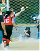 Nadia Lewis beats the throw and slides safely into home plate during Langdon's game against Midway-Minto. Photo by Larry Stokke
