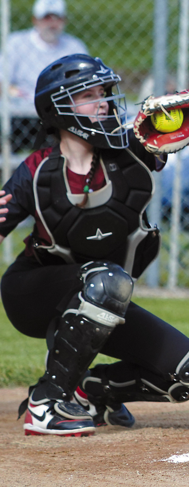 Bridget Pankratz snares a pitch from Nadia Lewis for a strike during Langdon Area/ Munich's victory over Larimore on June 25 in Munich. Photo by Larry Stokke