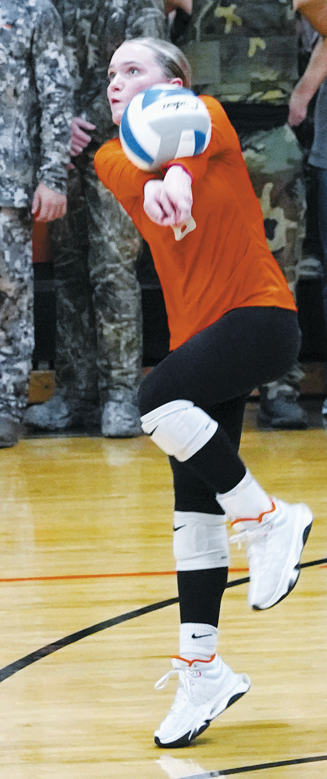 Remi Larson scoring her 1,000th dig in the game with the North Border Eagles. Photo by Larry Stokke.