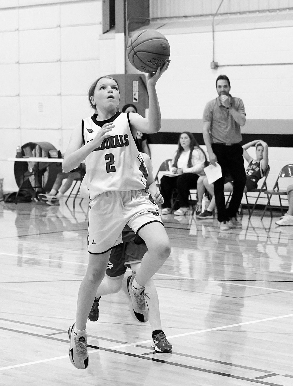 Sadie Pankratz drives in and drops a left handed lay-up in the Cards' win over the Spoilers. Photo by Larry Stokke.