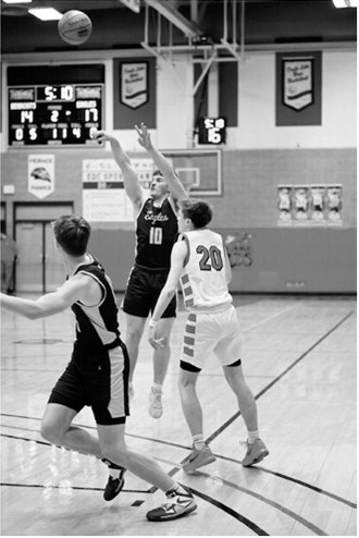 Colton Bailly shoots beyond the arch for three points. Photo by Ashley Schafer