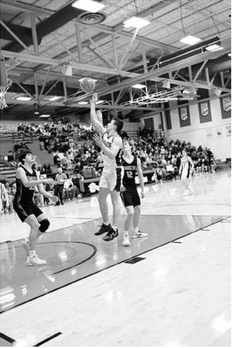 Brody Berg gets a jumper in the lane against the Chargers. Photo by Ashley Schafer