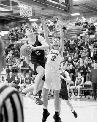 Kaden Moore had a team high 18 points in the 3rd place game against North Star. Garret Willits drives past Hunter Hagler and drops in a basket. Photo by Larry Stokke Photo by Larry Stokke