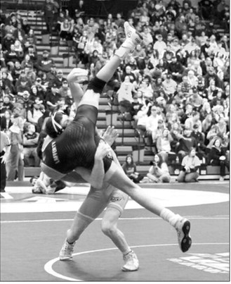 Collin Longtin takes his opponent off the mat and pins him in 1 minute 28 seconds, punching his ticket to the State Tournament. Photo by Larry Stokke
