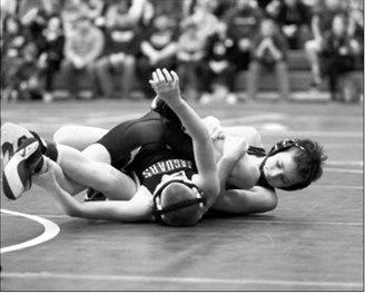 Johnny Robinson won by pinning his opponent and qualified for a trip to the State Meet. Photo by Larry Stokke