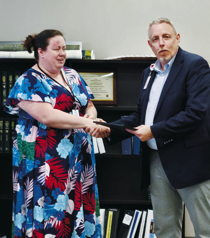 accepts the Pediatric Prepared Ambulance Award from Chettie Greer, the EMSC program manager. Photo by Nick Vorlage. Wayne Reid, CEO of Langdon Prairie Health,
