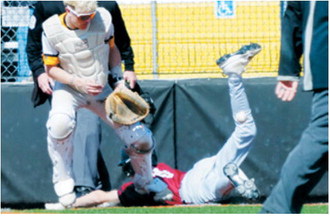 Grady Pankratz slides into home plate beating the tag out scoring for the Cards in the win over Park River. Photo by Larry Stokke