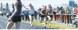 Ella Goodman crosses the finish line in the 4x400-meter relay at the regional meet. Goodman, Taya Feist, Olivia Lorenz and Hallie Overby placed second for the Langdon Area/Munich Cardinals, while the PCN Grizzlies finished fourth. Photo by Ashley Schafer