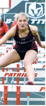 Meggy Hetletved placed third in the 100-meter hurdles at the regional meet in Mayville for the Cardinals. Photo by Larry Stokke