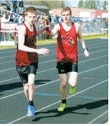 Noah Foster hands the baton to brother Kaleb Foster during the 4x800-meter relay at the regional meet in Mayville on May 16. Foster, Parker McDonald, Logan Mackall and Kaleb Foster placed sixth for the Langdon Area/Munich Cardinals. Photo by Larry Stokke
