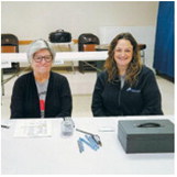 From left - right: Sandy LeTexier and Corin Keena man the booth at last week’s fundraiser. Photo by Gwen Zorn.