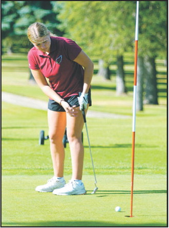 Colby Forest watches her putt during the Langdon Invitational on Aug. 24. Forest earned medalist honors with a score of 95. Photo by Larry Stokke